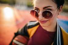 A woman with sunglasses smiles at the camera.