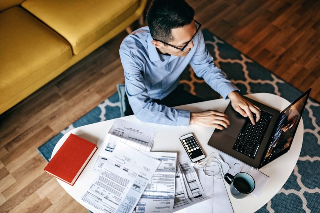 A man goes over his finances at home.