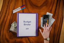 A budget binder is shown.