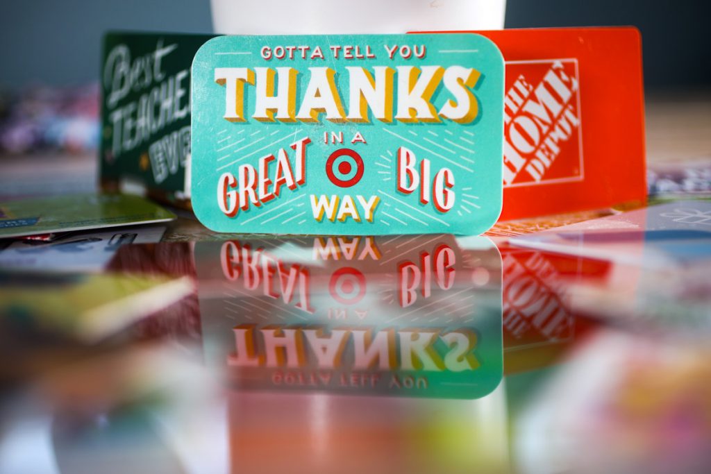 Gifts cards stand up on a table. Selling unused gift cards is a way to make money. 