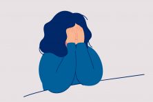 This illustration shows a woman with her hands over her eyes.