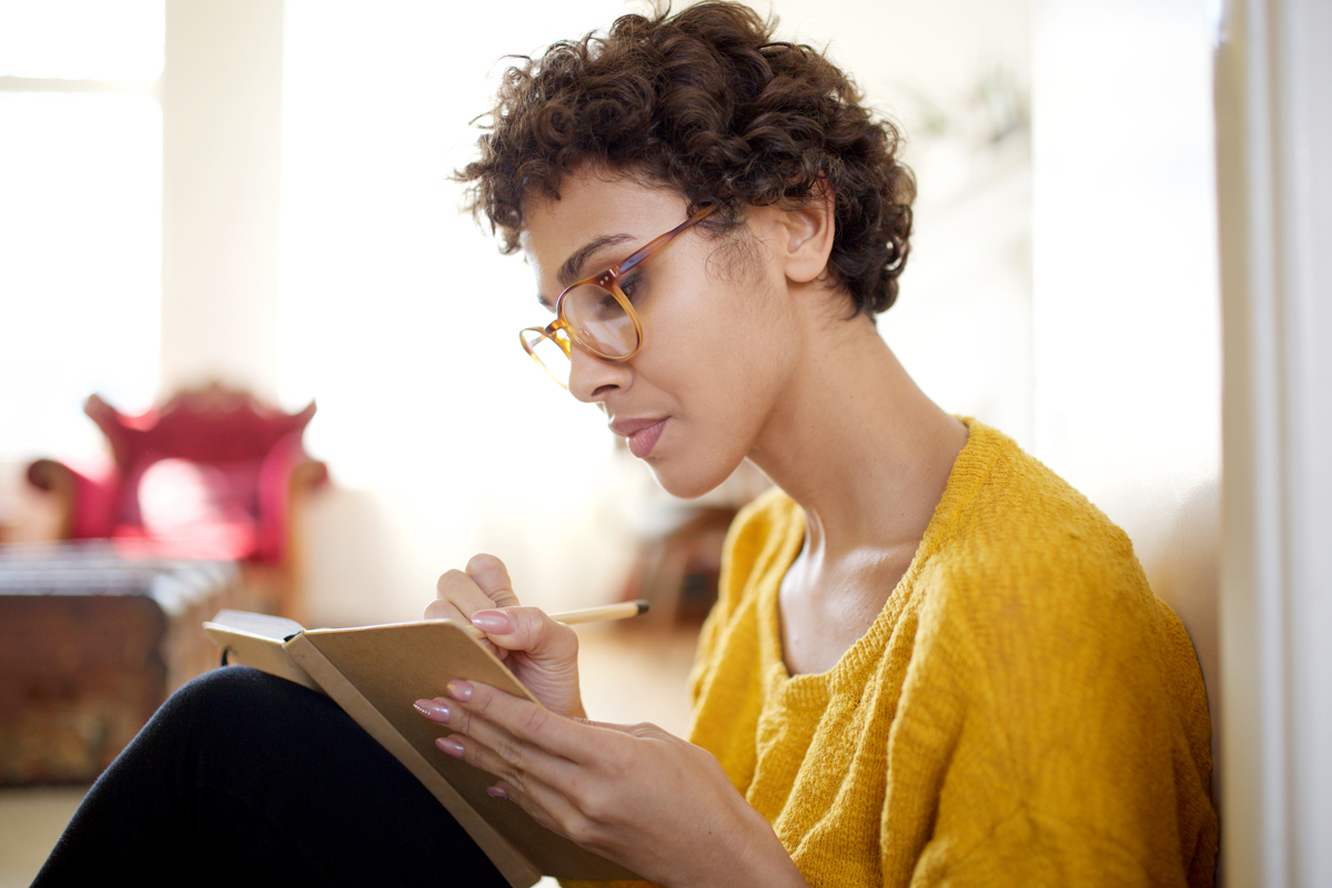 A woman writes in her journal.