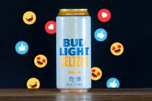A can of bud light seltzer is photographed with various emojis behind it in this illustration.