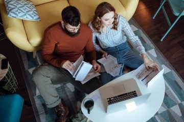 Person carefully managing their household budget on a limited income