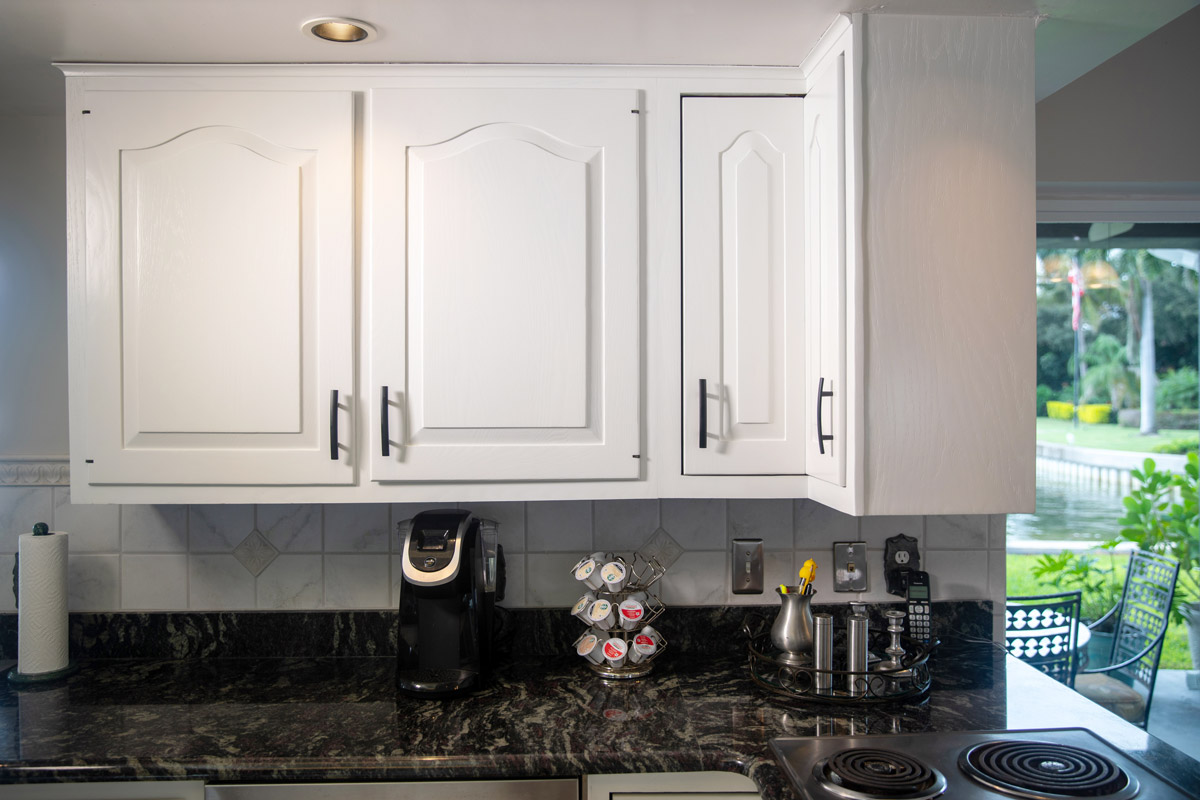 Cabinets with a fresh coat of white paint and updated handles. 