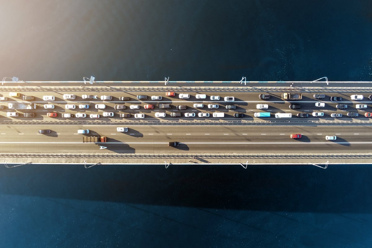 Vehicles drive across a bridge. 