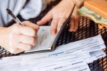 A woman writes a check. This story explains how to write a void check and why you'd need to write a void check.