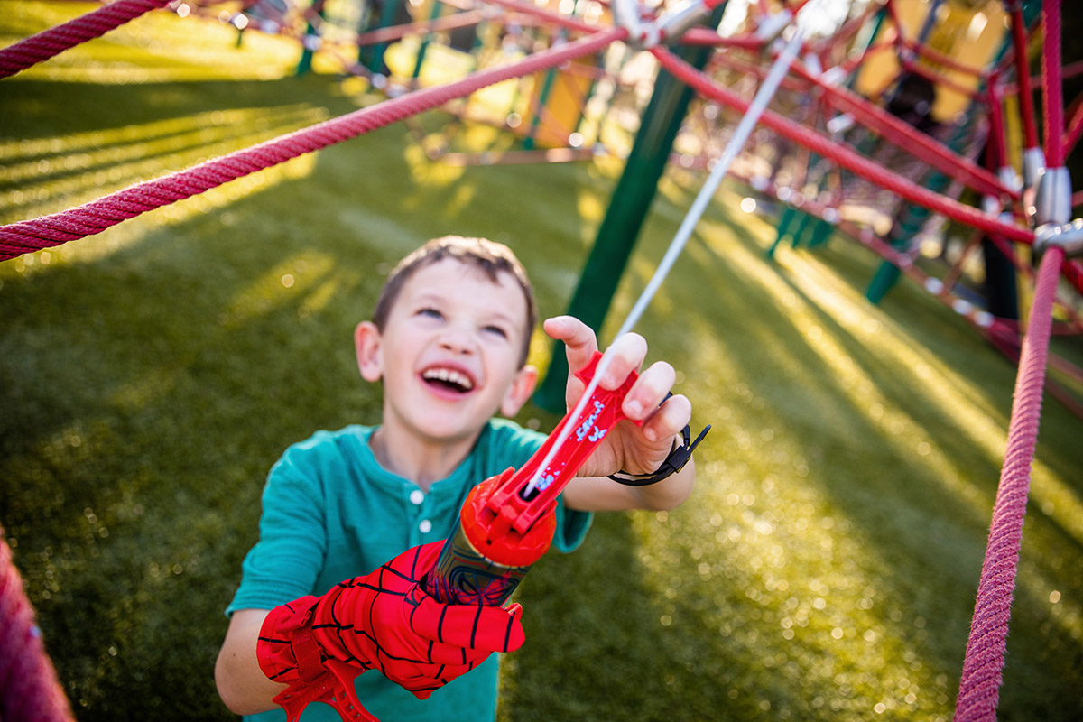 A kid plays with Marvel Spider-Man Super Web Slinger