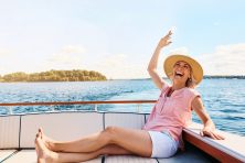 A woman enjoys her time on a private boat.