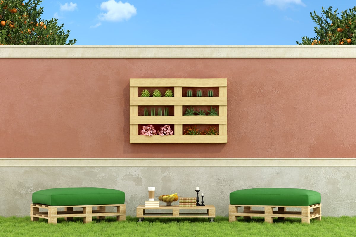 Outdoor furniture including a table, two chairs and a shelf to hold plants are made out of pallet wood. 