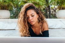 A woman does work on a laptop while on vacation.
