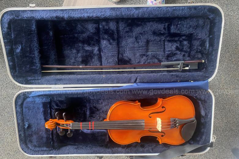 A violin sits in its case. 