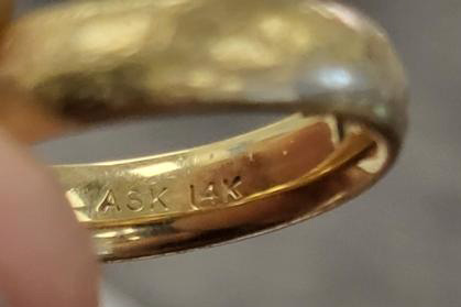 A gold ring is held. 
