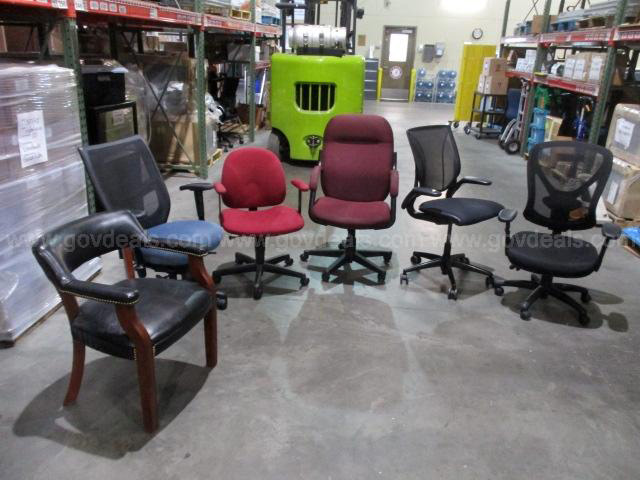 Office chairs sit in a warehouse. 