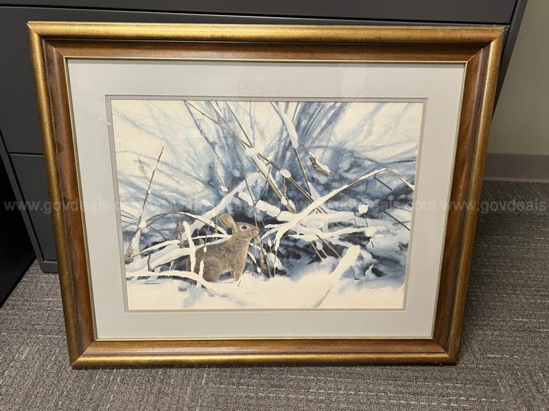 A photo of a snow bunny sits in a frame. 