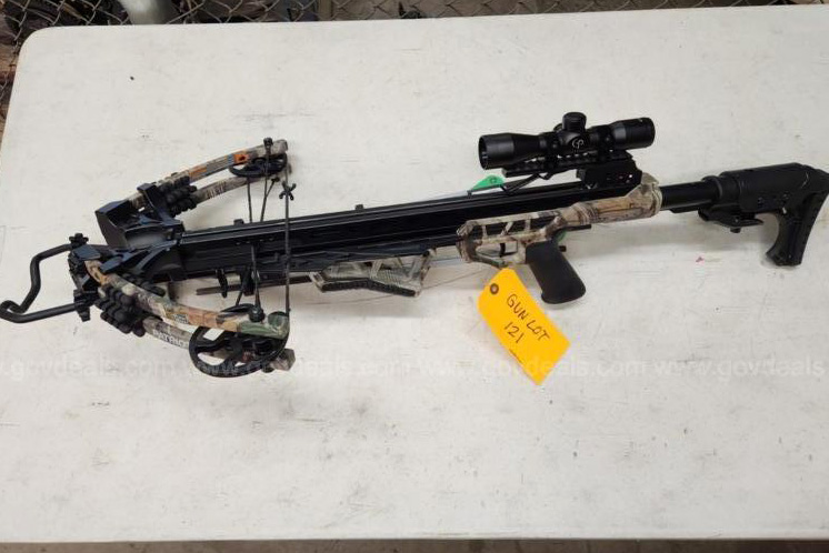 A crossbow sits on a table. 