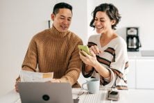 A couple pay their bill online.