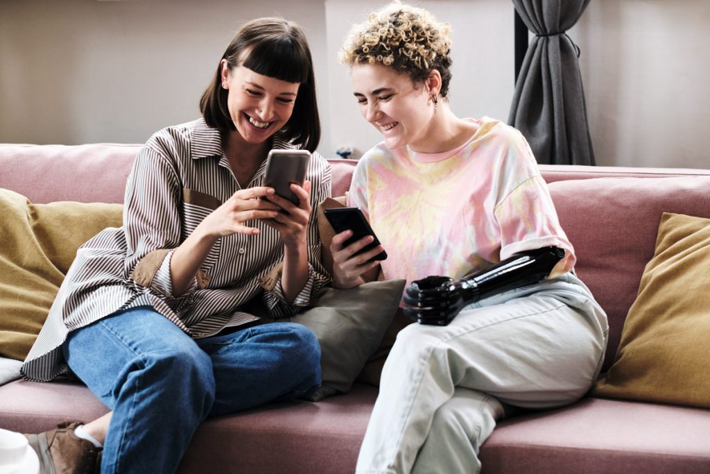 Couple reviewing shared finances together on a smartphone