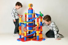Two young boys play with a plastic garage playset.
