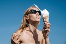A woman eats ice cream.