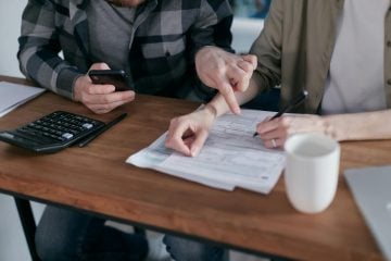 Person analyzing their monthly spending patterns using an expense tracking app