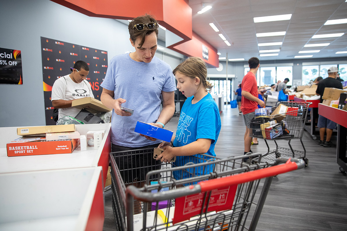 A father and daughter find items to buy at Hotbins.