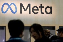 People attend a conference with the Meta logo above them.