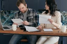 Person reviewing bills and concerned about making rent payment