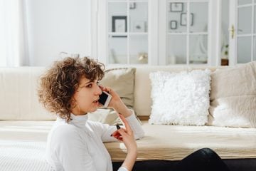 Person calling their landlord or a rental assistance hotline to discuss payment options