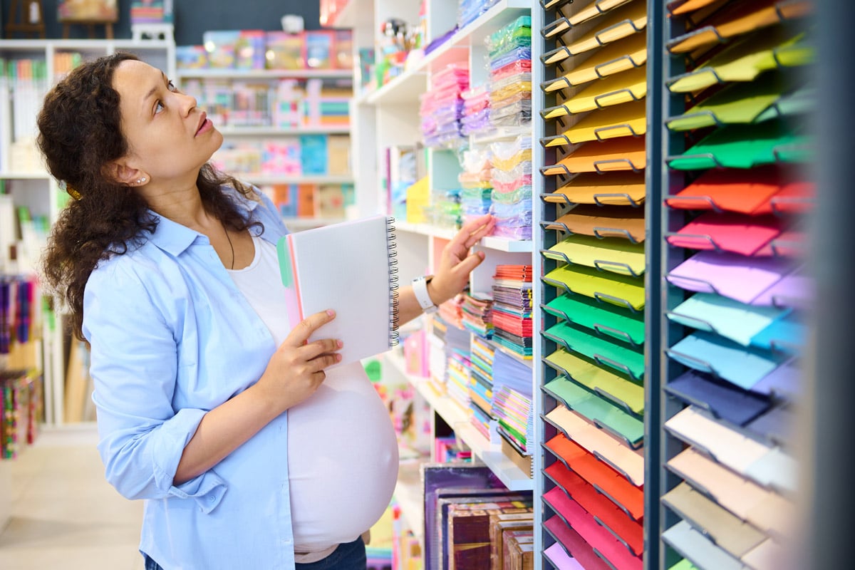 A pregnant woman shops for office supplies.