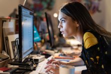 A woman codes on a computer.