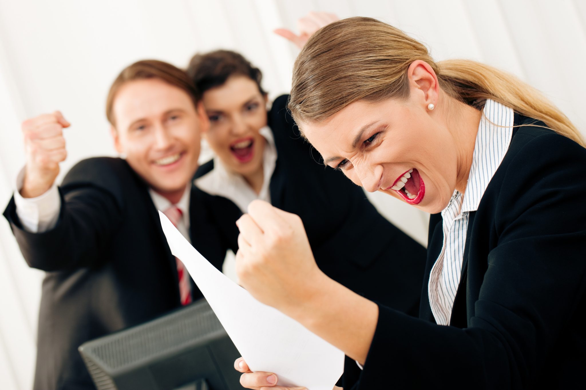 Business people celebrating a success in an office