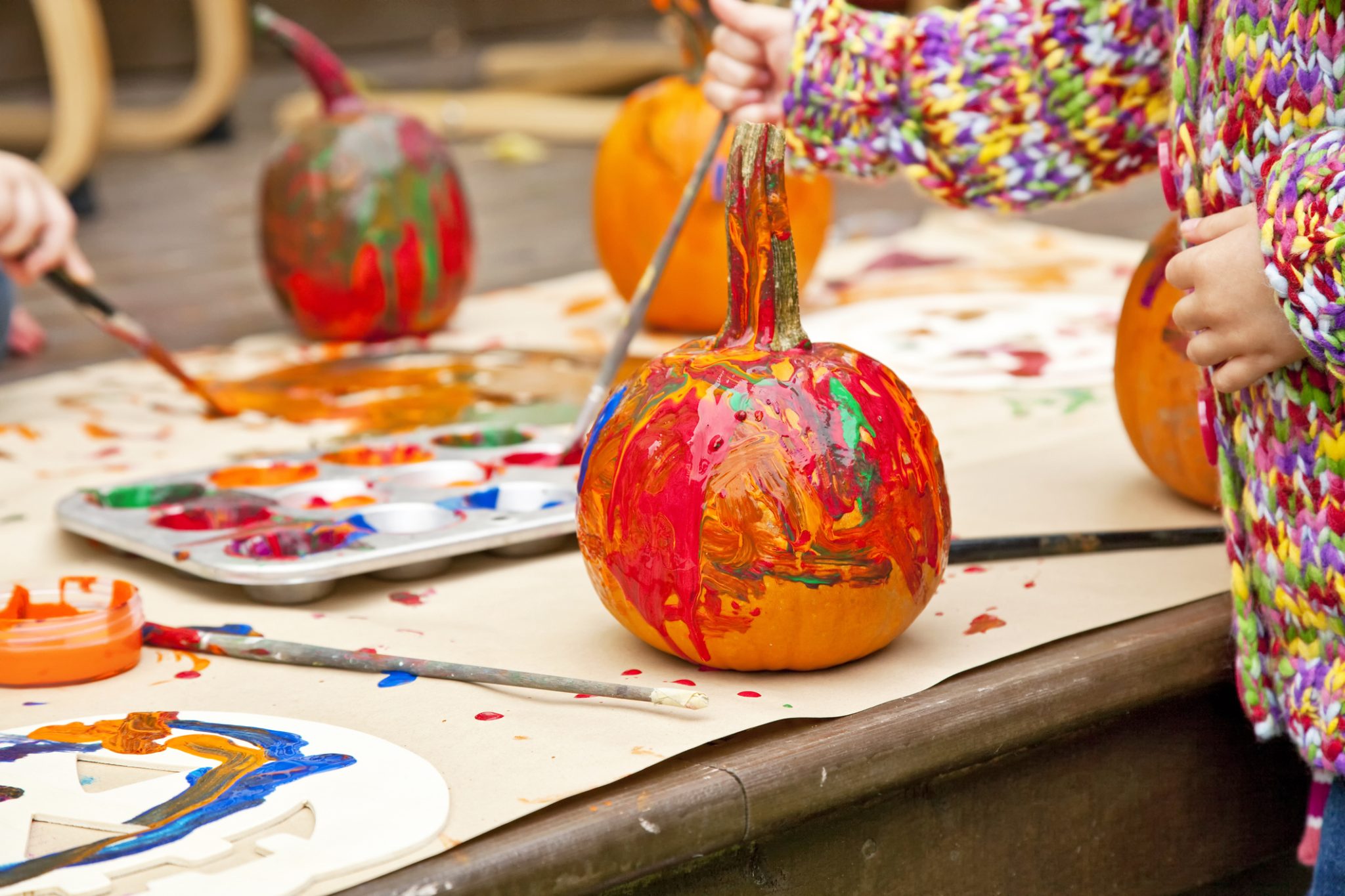 Pumpkins colorfully painted by children.