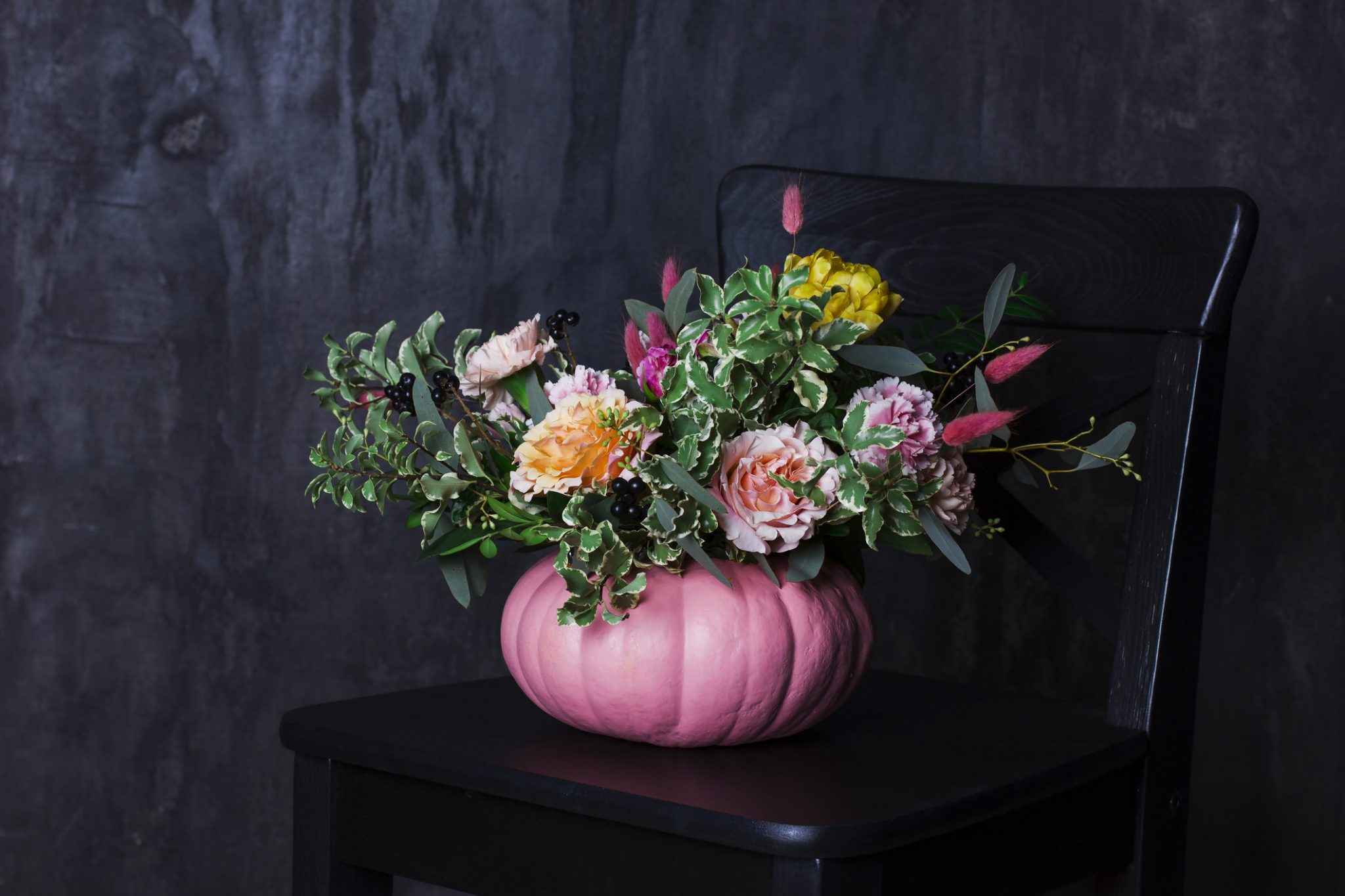 Autumn Floral Bouquet In Pumpkin Vase On Black Chair