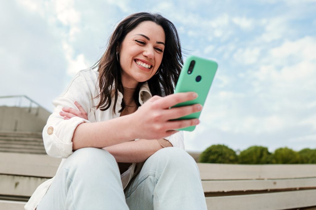 Person browsing budgeting app options on a smartphone