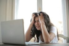 Frustrated woman looking at her laptop screen.