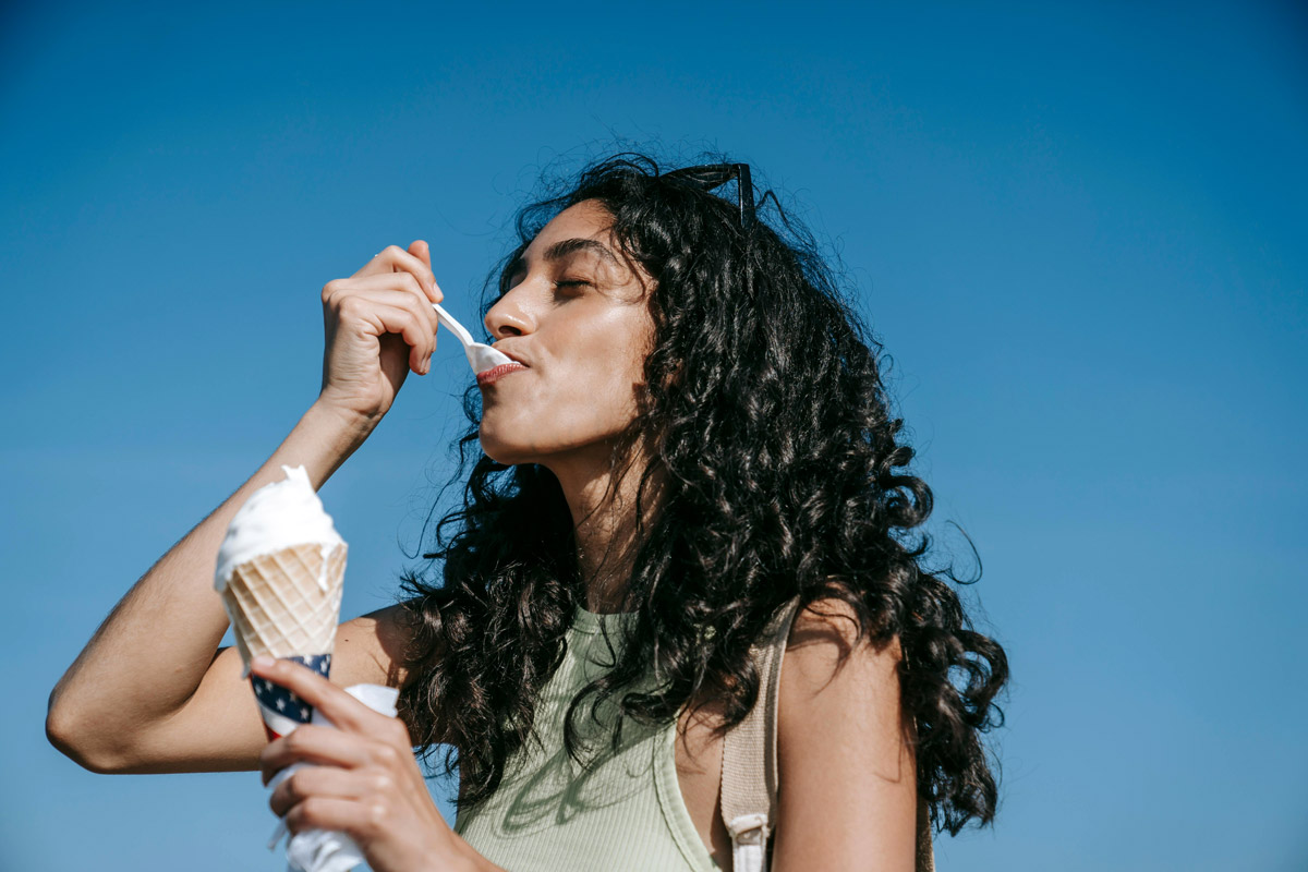 A woman eats ice cream.