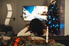 A woman watches a movie during the holiday season.
