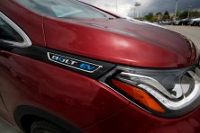 The electric vehicle logo shines off the fender of an unsold 2019 Chevrolet Bolt at a Chevrolet dealership on Sunday, May 19, 2019 in Englewood, Colo. David Zalubowski/AP Photo
