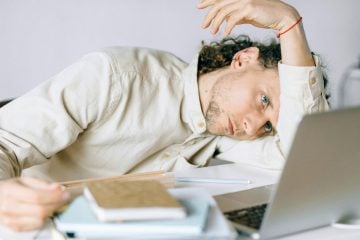 A man looks stressed as he works from home.