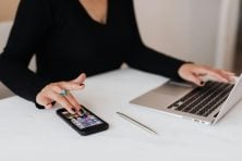 Someone uses their phone and computer.
