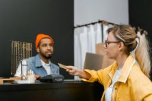 A woman uses her charge card at a retail store.
