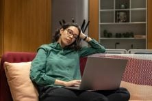 A woman works from home on her laptop.