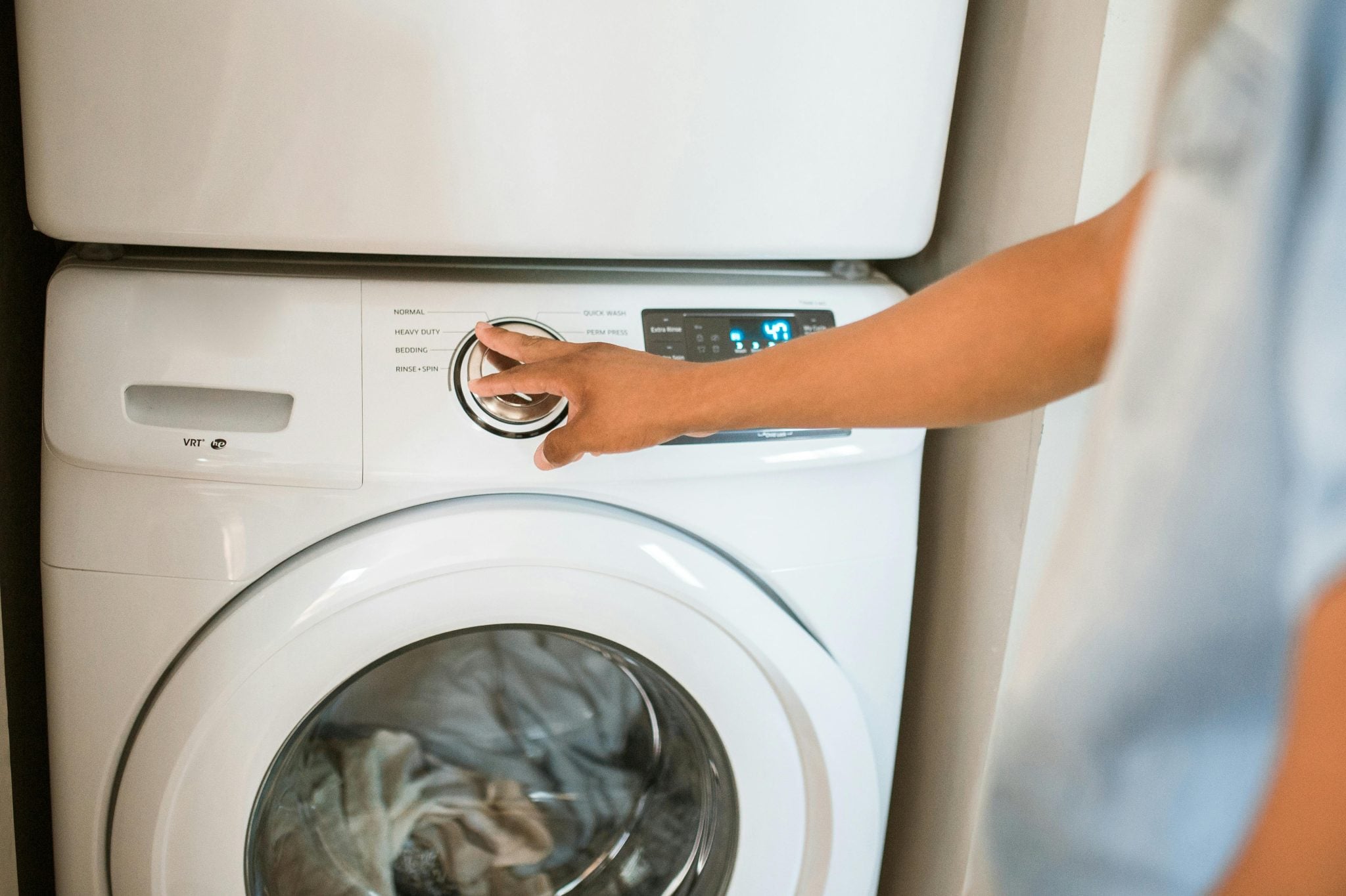 Someone changes the setting on a washer. 