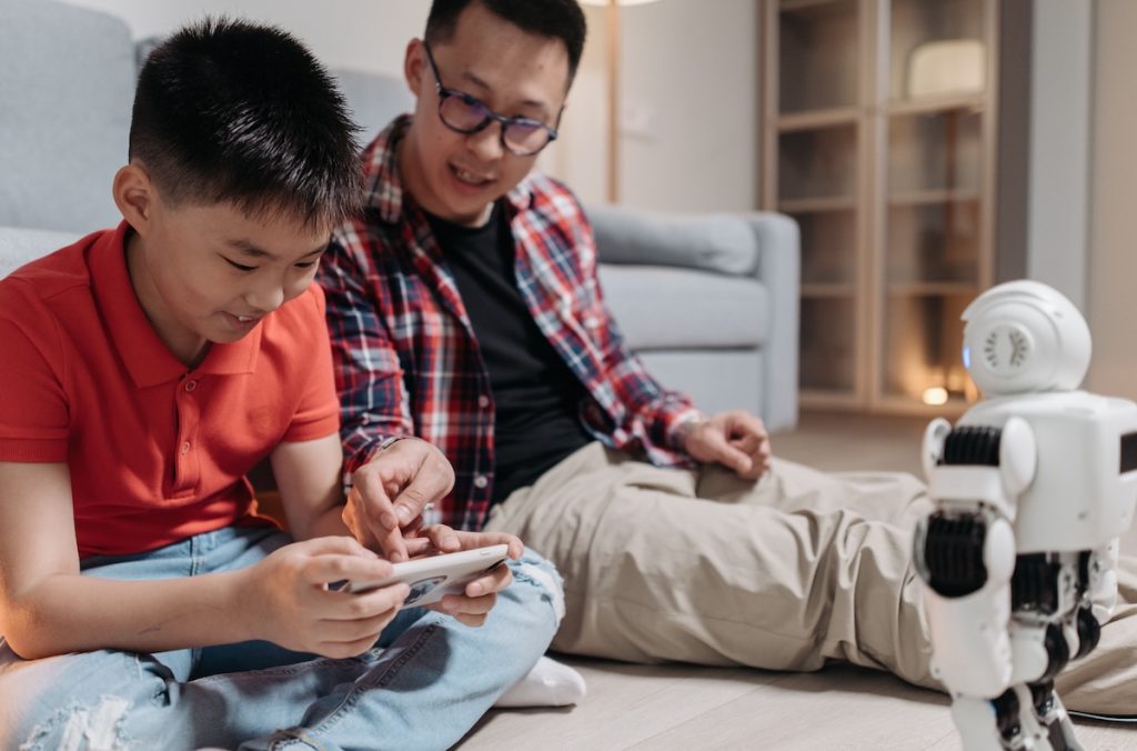 Parent and child reviewing the child's savings progress together using a financial app