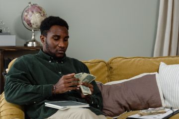 Person using a simplified anti-budget approach to manage their finances without detailed tracking