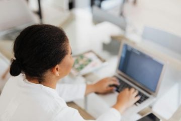 Person reviewing their monthly financial plan using Simplifi by Quicken