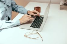 Someone types on a laptop